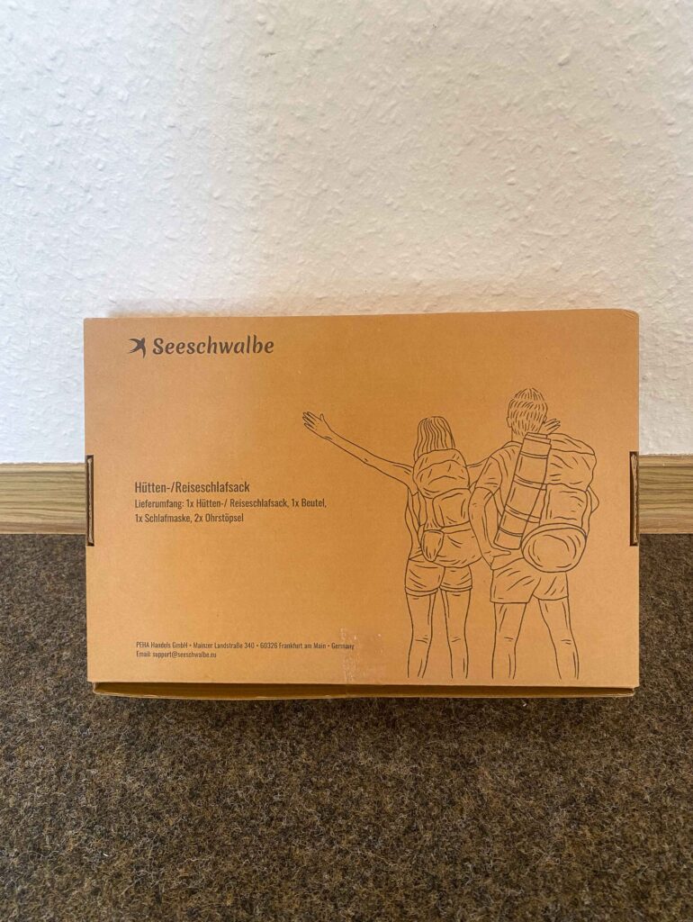 Geschlossener Verpackungskarton von hinten mit Illustration zweier Wanderer.